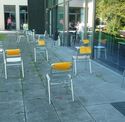 A test parcour made of multiple, randomly arranged, chairs with yellow markers attached to their backside.